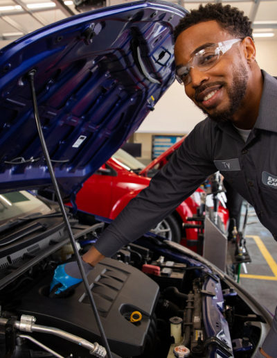 Express Care Employee under the hood of a car